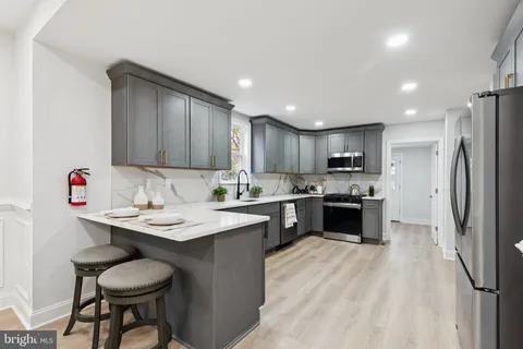 a stove top oven sitting inside of a kitchen