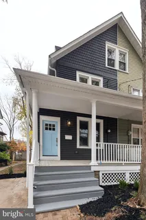 a front view of a house with a tree