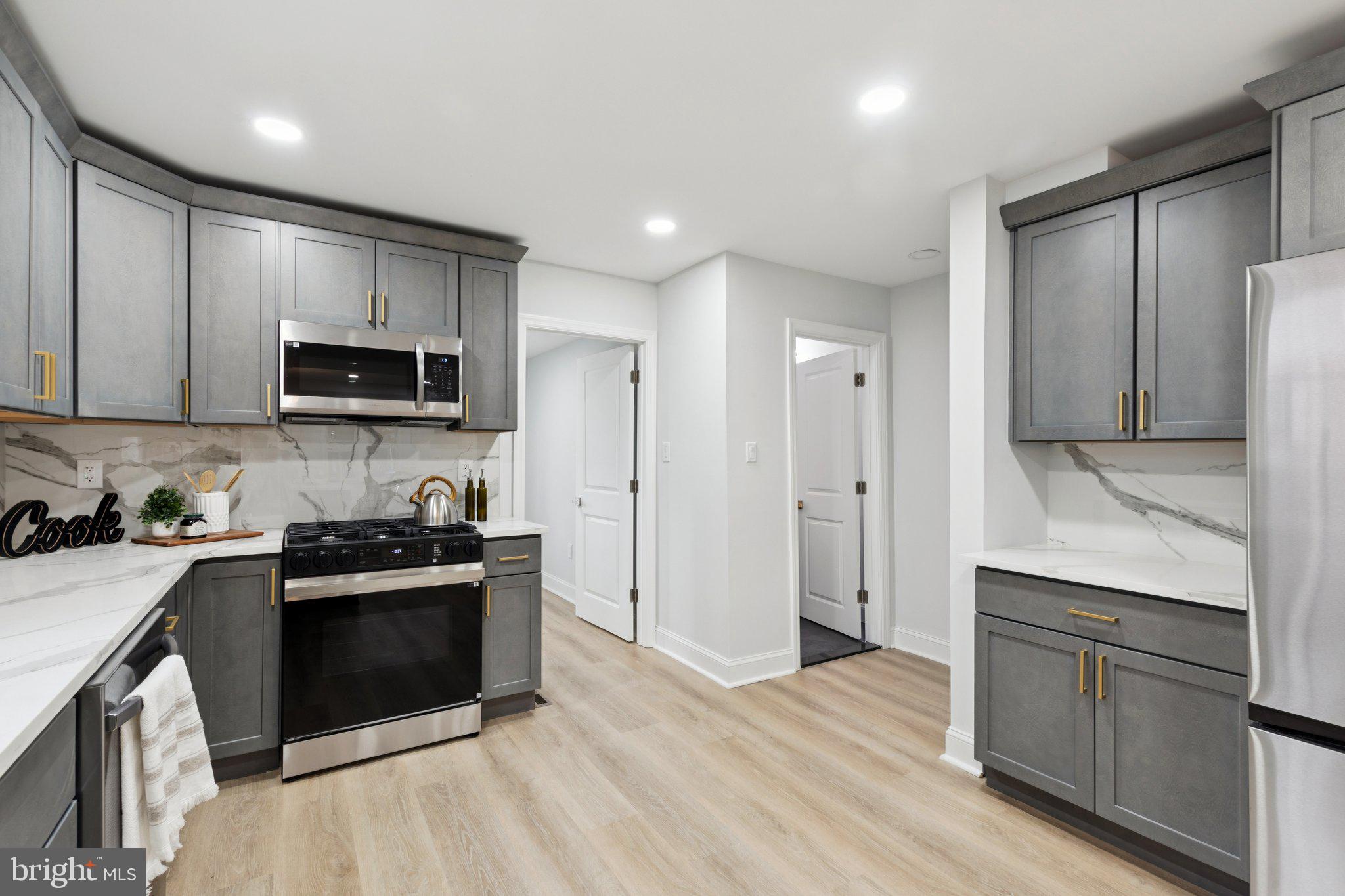 125 West Summit Avenue Haddonfield, NJ 08033 - Photo 25 of 68 a kitchen with stainless steel appliances granite countertop a stove a sink and a refrigerator