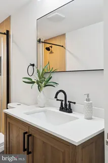 a bathroom with a sink vanity and mirror