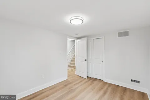 a view of staircase with white walls and railing