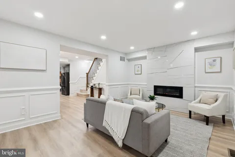 a living room with furniture a rug and a fireplace