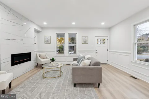 a living room with a couch and a potted plant