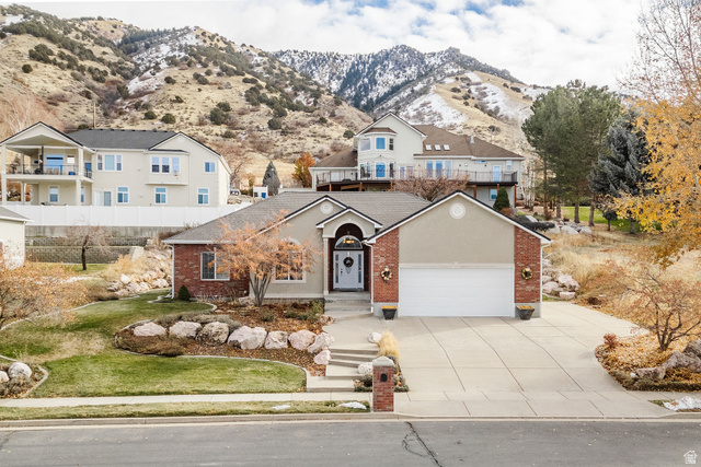 240 Bugle Way Providence, UT 84332 - Photo 15 of 15 Ranch-style exterior featuring a two-car garage, brick and stucco facade, and a concrete driveway