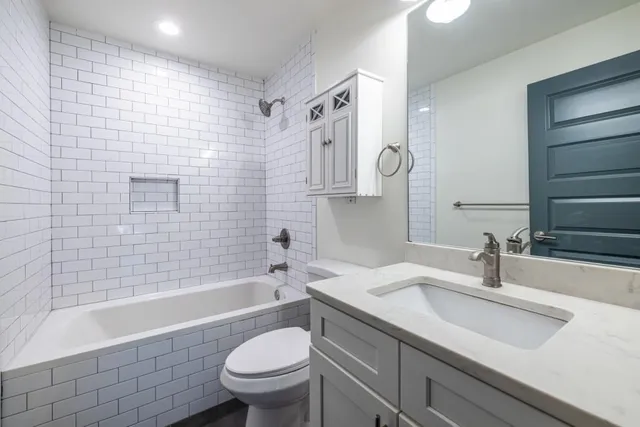 a bathroom with a sink a toilet and bathtub