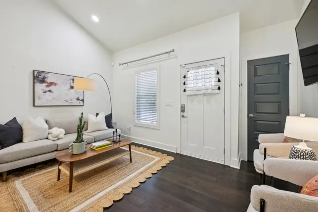 a living room with furniture and a wooden floor