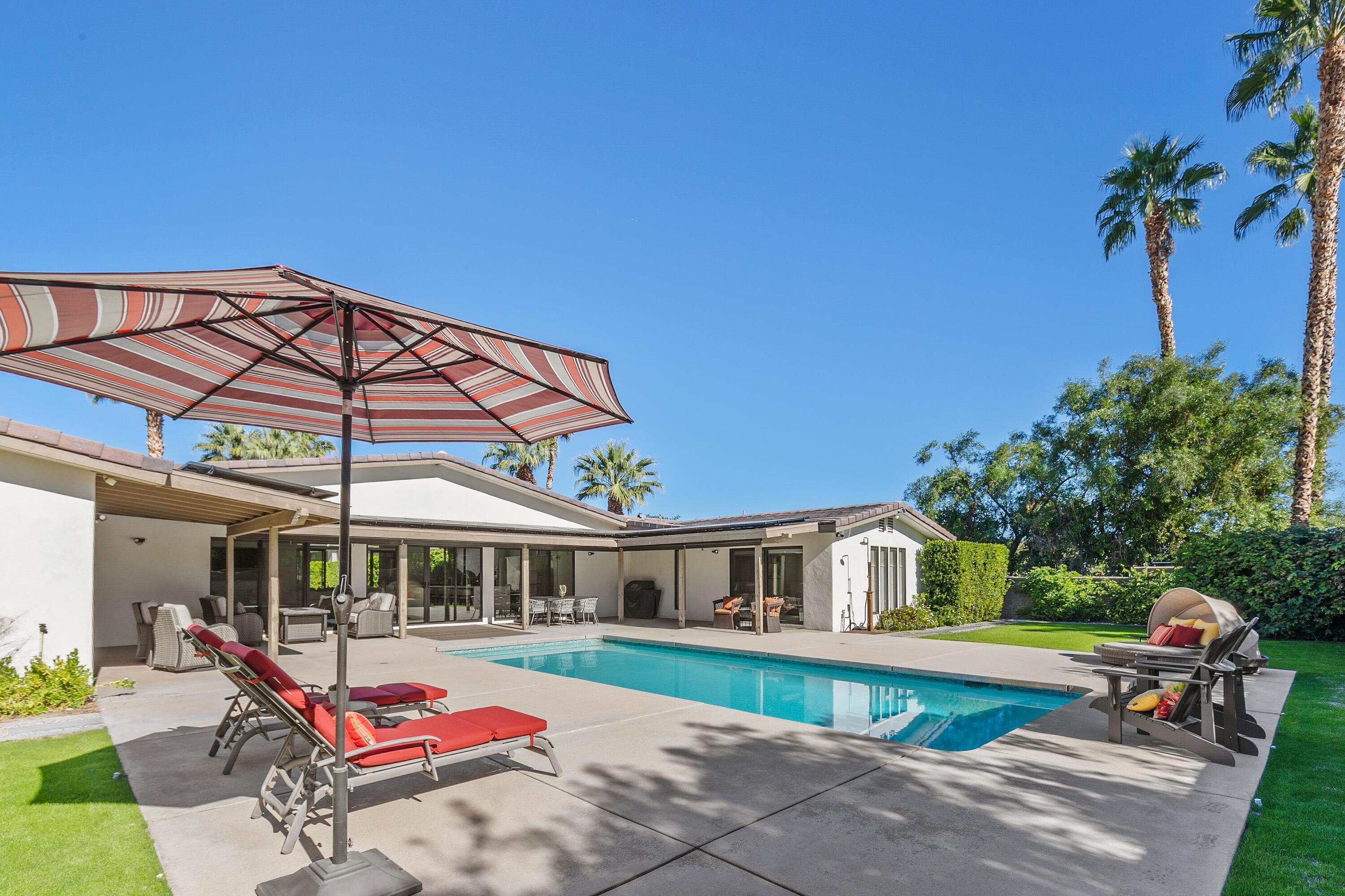 74155 Mockingbird Trail Indian Wells, CA 92210 - Photo 42 of 55 a front view of a house with porch and garden