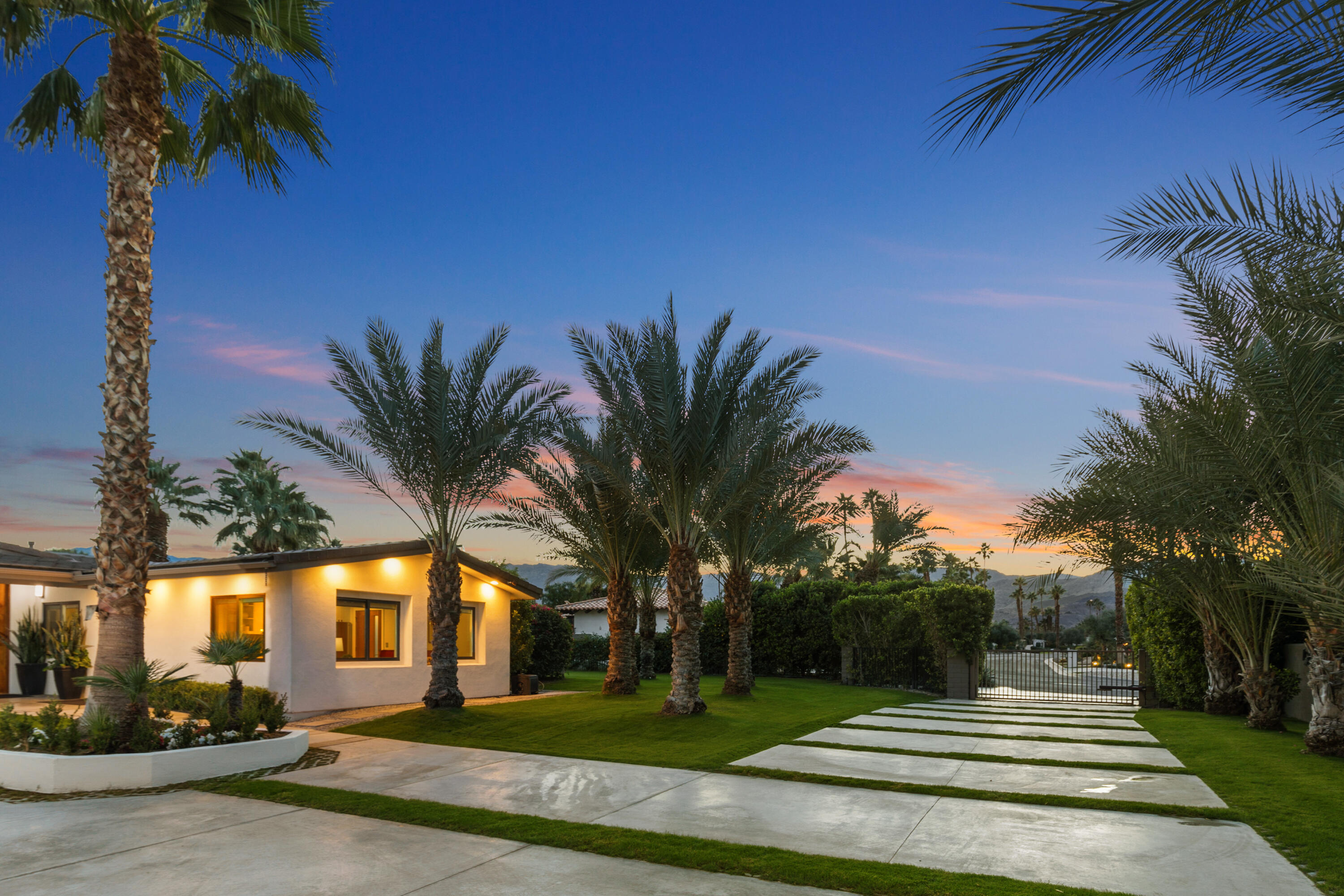 74155 Mockingbird Trail Indian Wells, CA 92210 - Photo 48 of 55 a front view of a house with a garden and trees