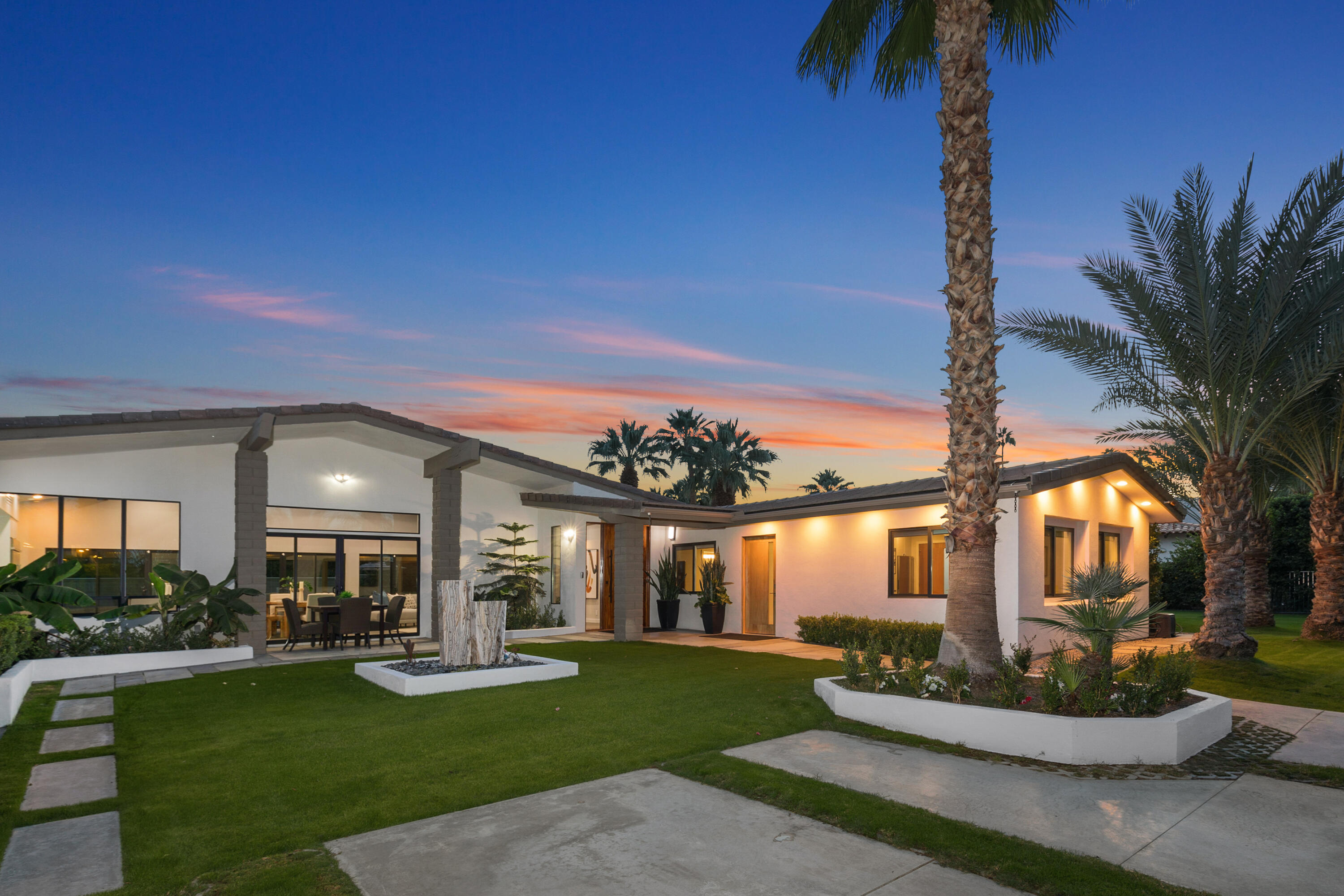 74155 Mockingbird Trail Indian Wells, CA 92210 - Photo 49 of 55 a front view of a house with a garden and patio