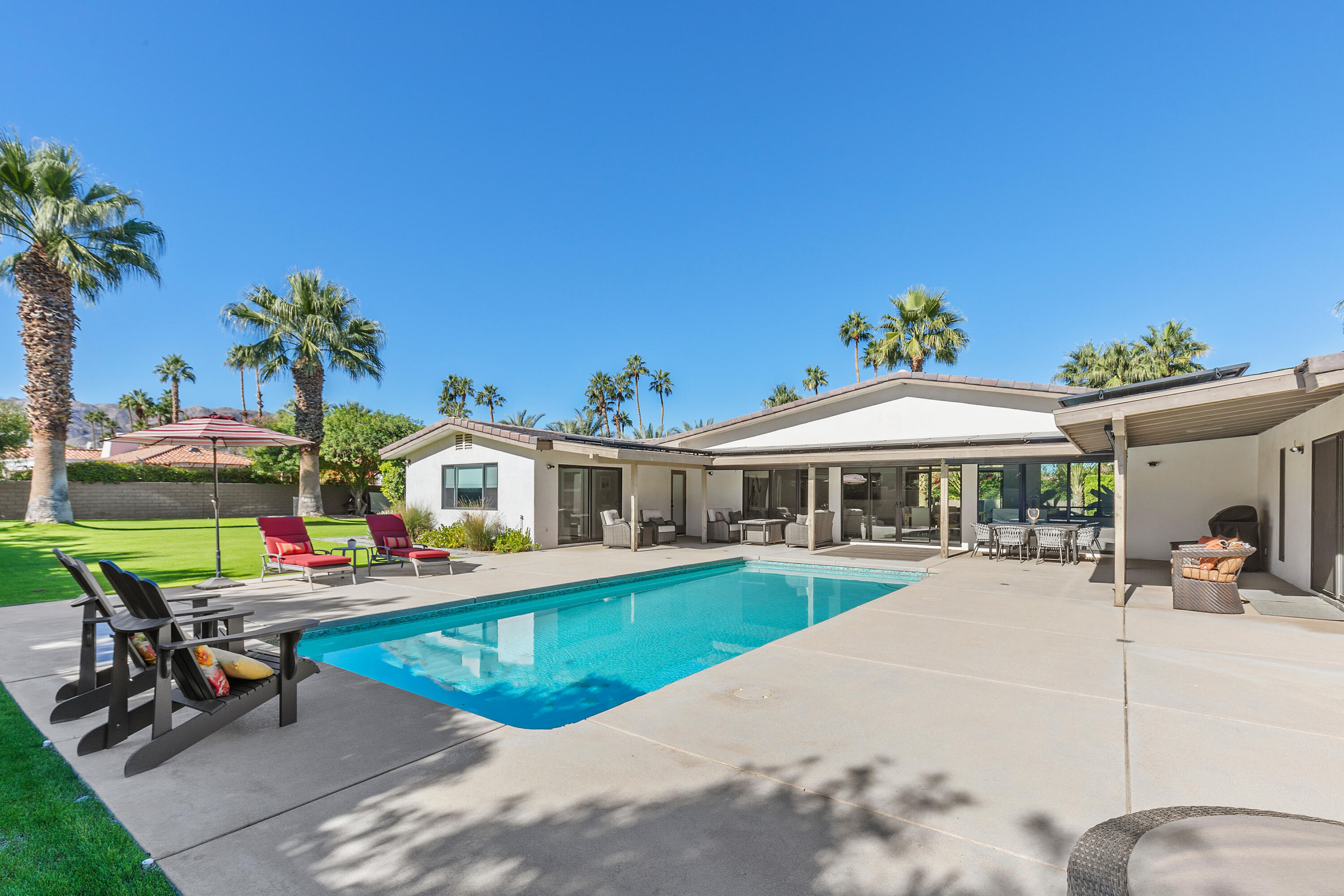 74155 Mockingbird Trail Indian Wells, CA 92210 - Photo 5 of 55 a view of a house with swimming pool and sitting area