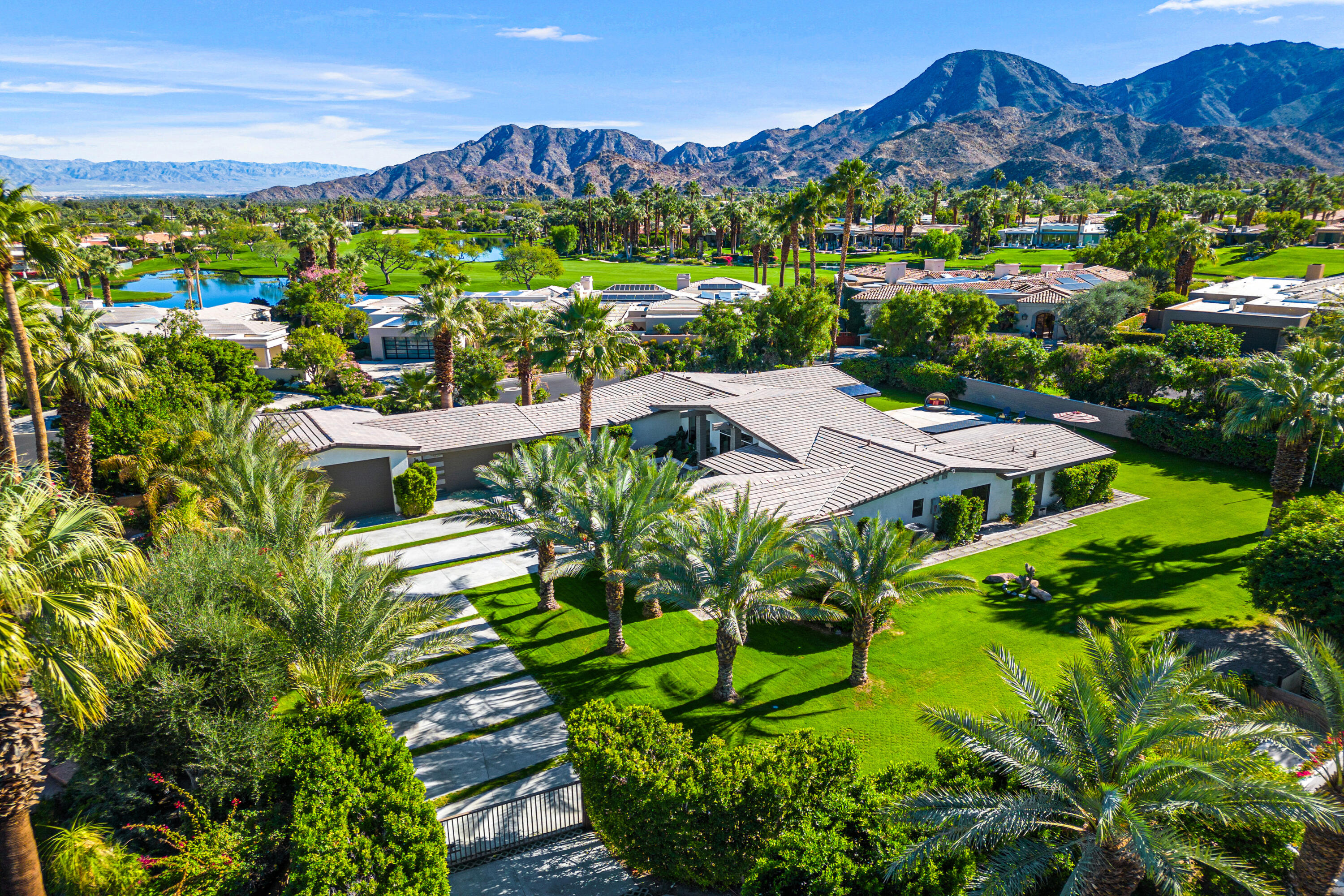 74155 Mockingbird Trail Indian Wells, CA 92210 - Photo 6 of 55 a view of a garden with a building in the background