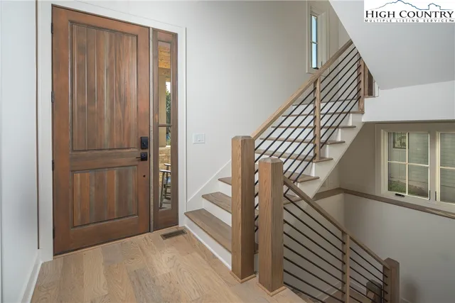 a living room with furniture and a floor to ceiling window