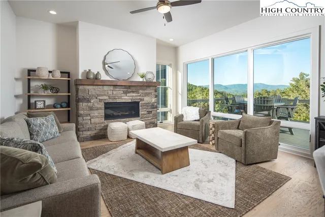 a dining table with chairs and kitchen view