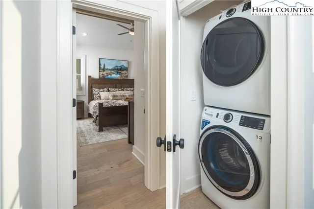 a view of a swimming pool and lounge chairs in back of a house