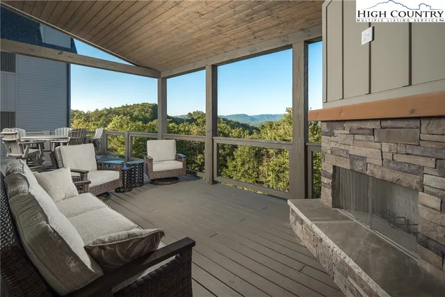 a view of a chairs and table in patio with a barbeque