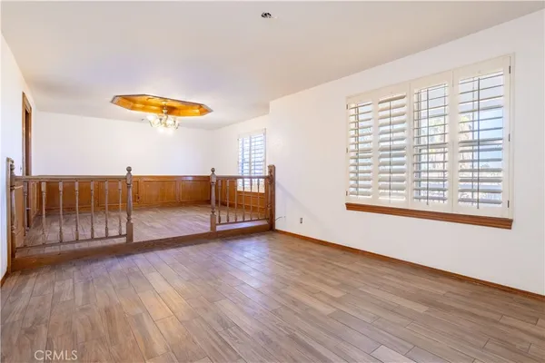 a view of a room with wooden floor and window