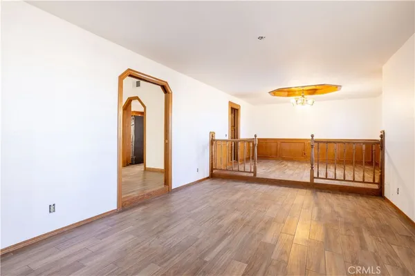 a view of a room with wooden floor