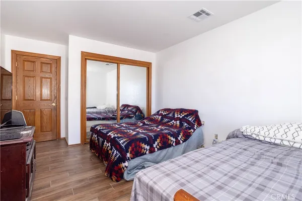 a bedroom with two beds and a chair