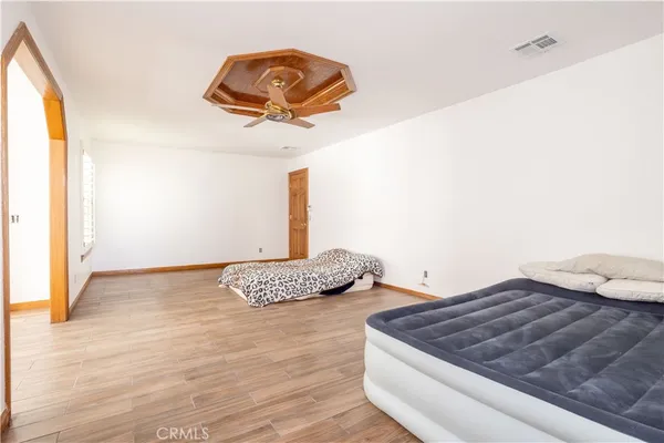 a bedroom with a bed and a painting on the wall