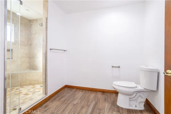 a bathroom with a toilet and a shower