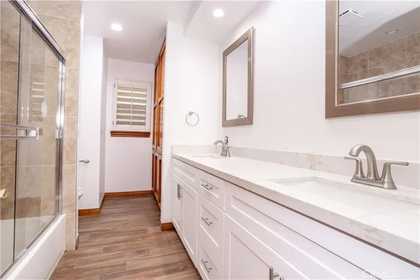 a bathroom with a double vanity sink and a mirror