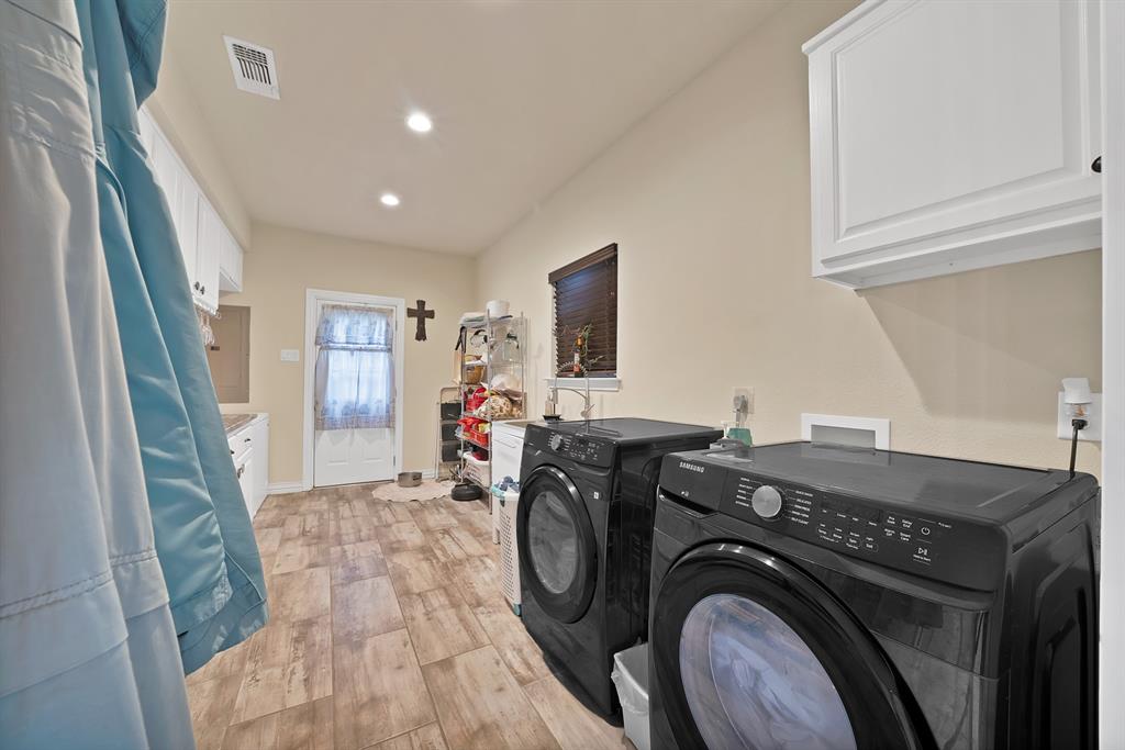 100 Shadle Ridge Court Poolville, TX 76487 - Photo 12 of 40 Utility room featuring wood-finish flooring, recessed lighting, white upper cabinetry, and a window with blinds