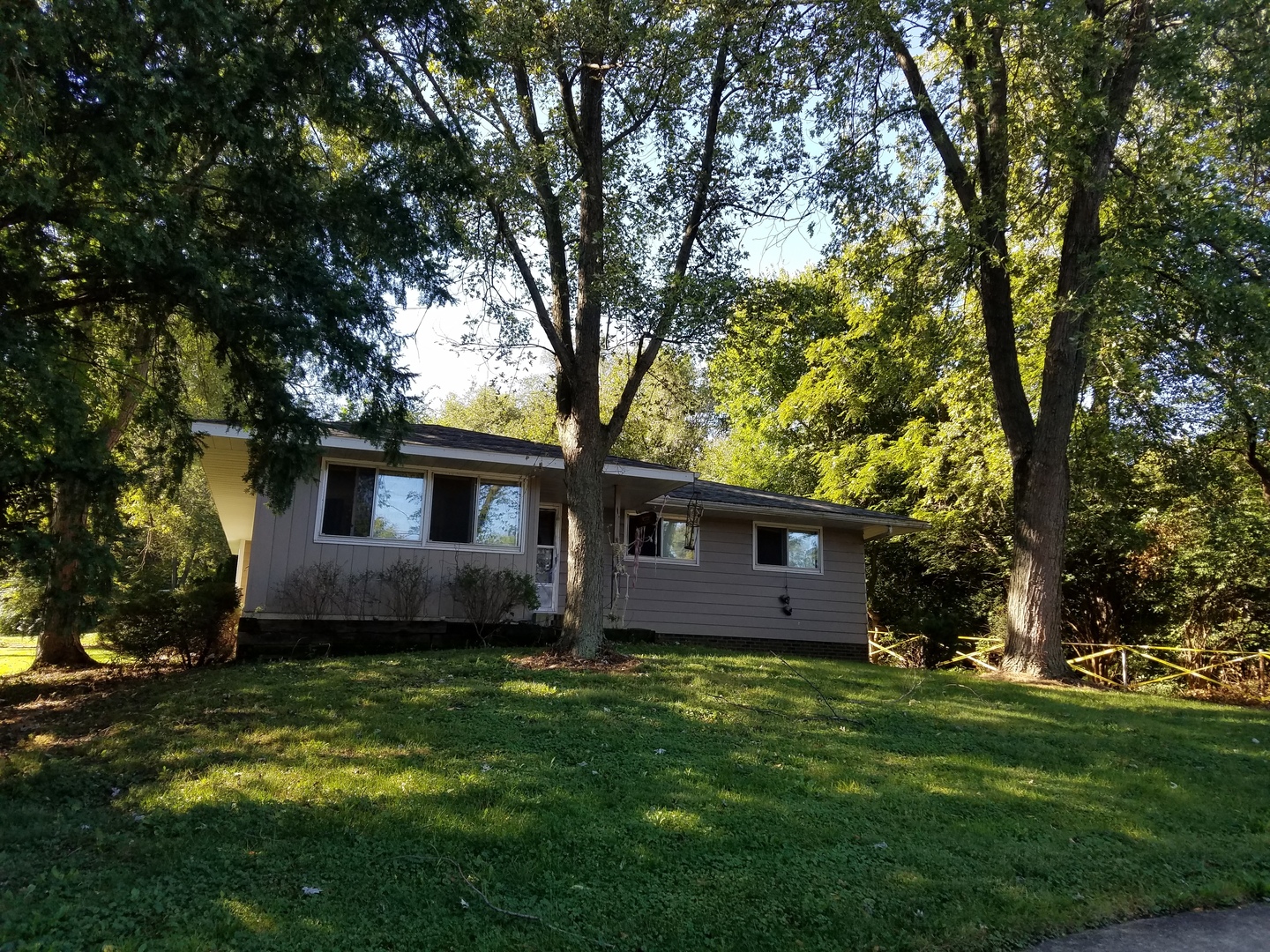 649 Front Street Lisle, IL 60532 - Photo 1 of 2 a view of a house with a small yard and a large tree