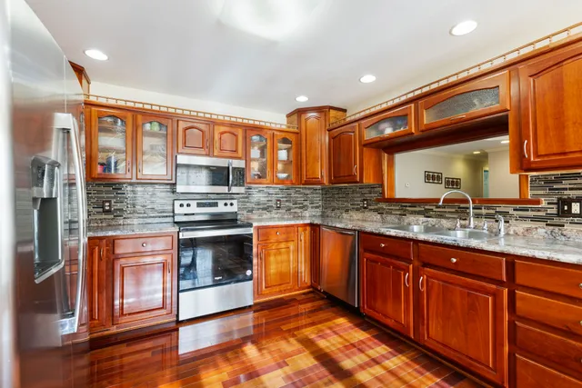 a spacious bathroom with a granite countertop sink and a large mirror