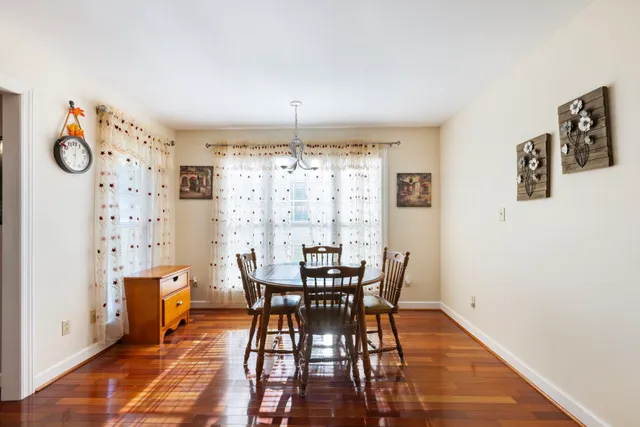 a view of a dining room with furniture and chandelier