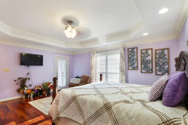 a bathroom with a granite countertop bathtub a sink and a large mirror