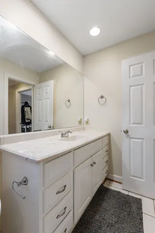 a view of a big house with a big yard and large trees