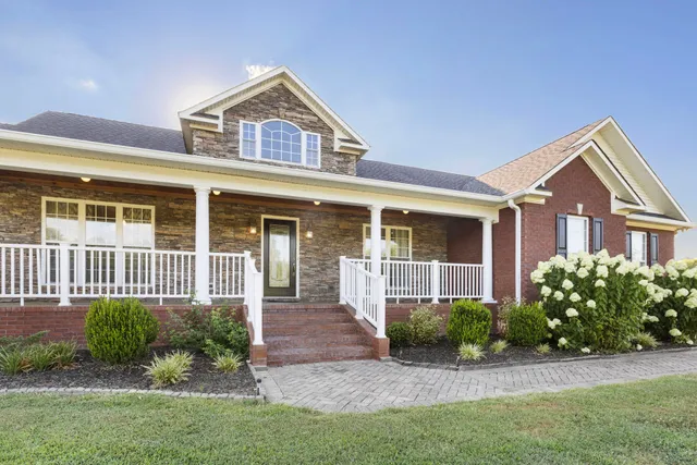 a front view of a house with a garden and plants