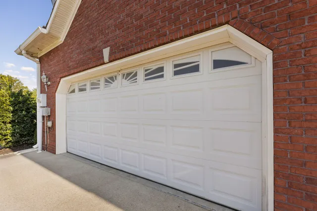 a view of a house with swimming pool and a yard