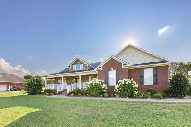 a view of a porch with wooden floor and fence