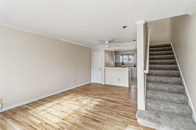 a view of a kitchen with wooden floor and stairs