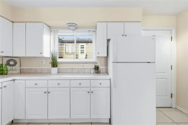 a white refrigerator freezer sitting inside of a kitchen