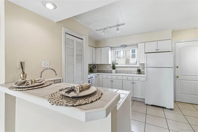 a kitchen with appliances a sink and cabinets