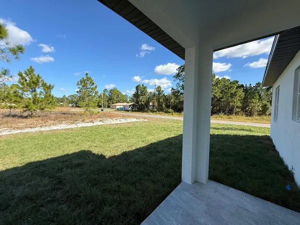 a view of a field with an ocean view