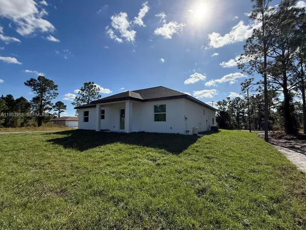 a view of a house with a backyard