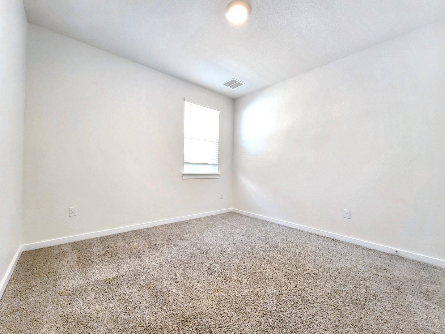 2329 Gabriels Horn Road Leander, TX 78641 - Photo 15 of 23 An inviting room awaits personalization, complete with soft carpeting and a window offering natural light.