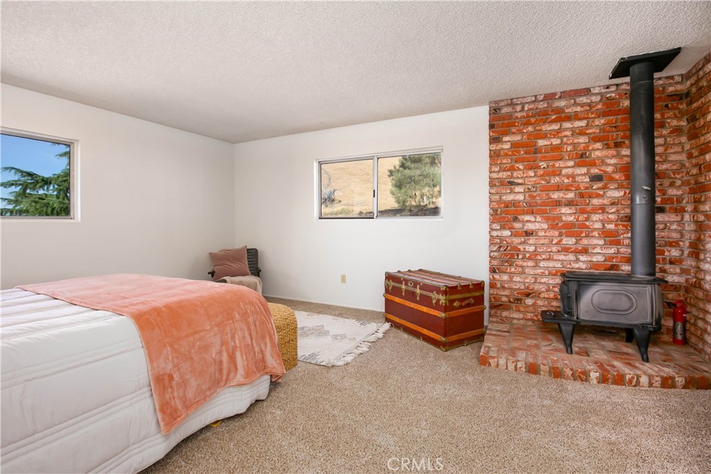 46404 Kings Canyon Road Lancaster, CA 93536 - Photo 20 of 41 a bedroom with a bed and a couch