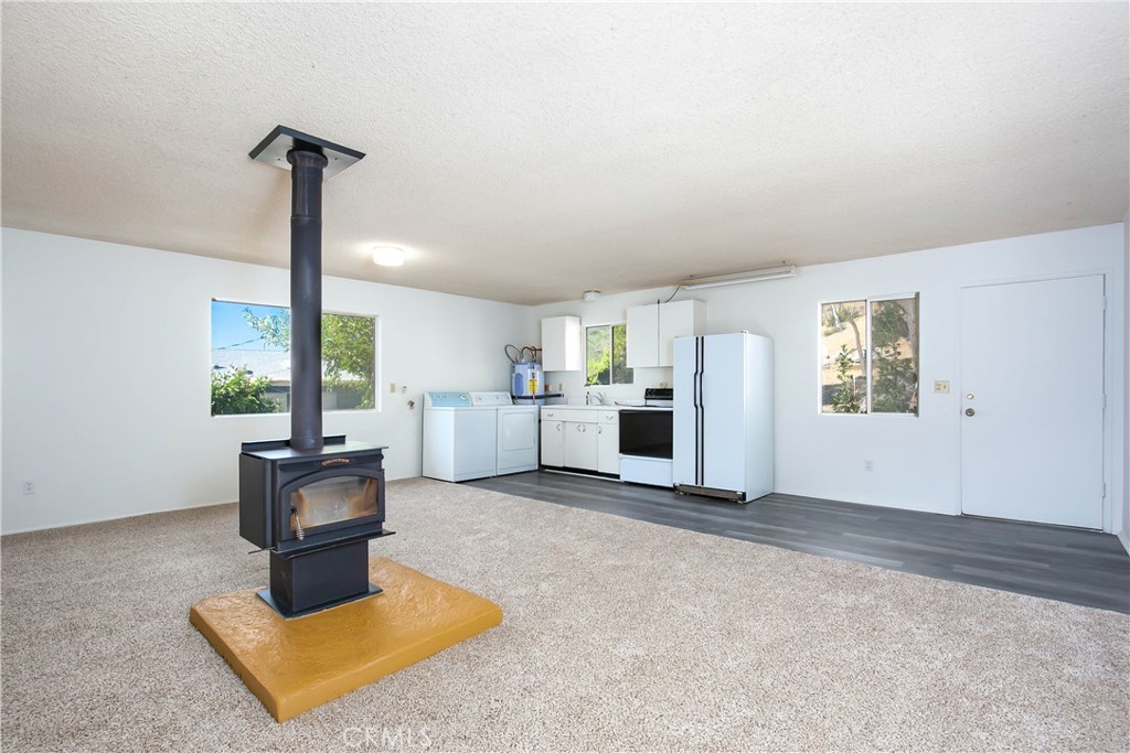 46404 Kings Canyon Road Lancaster, CA 93536 - Photo 24 of 41 a living room with furniture a window and kitchen view