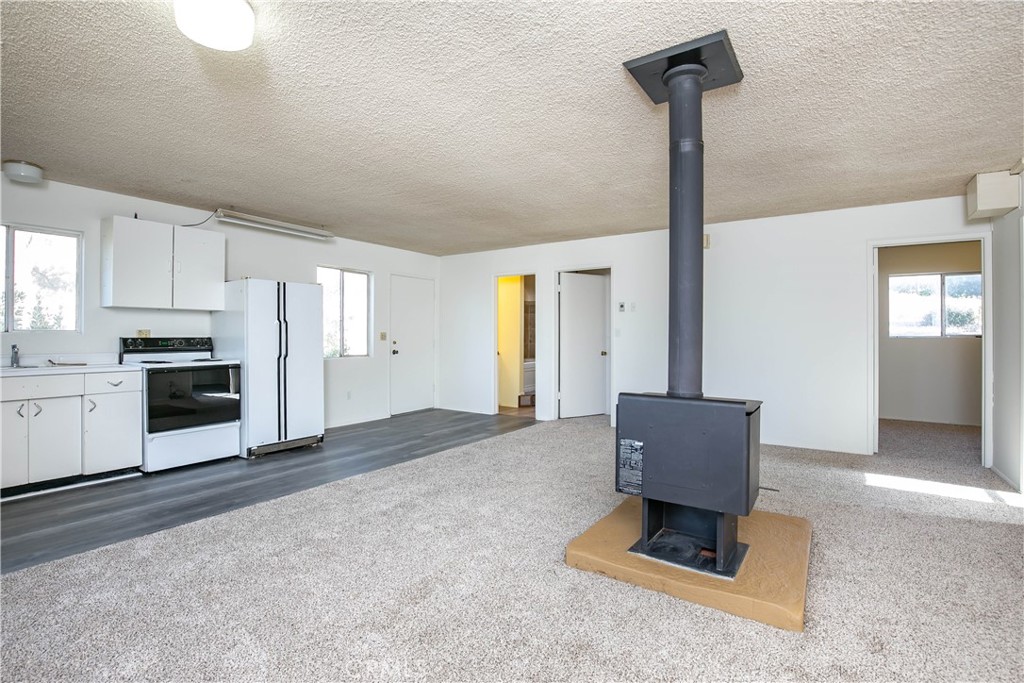 46404 Kings Canyon Road Lancaster, CA 93536 - Photo 25 of 41 a living room with stainless steel appliances kitchen island granite countertop furniture and a kitchen view