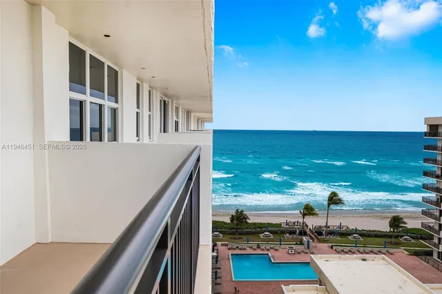 a view of a swimming pool with furniture