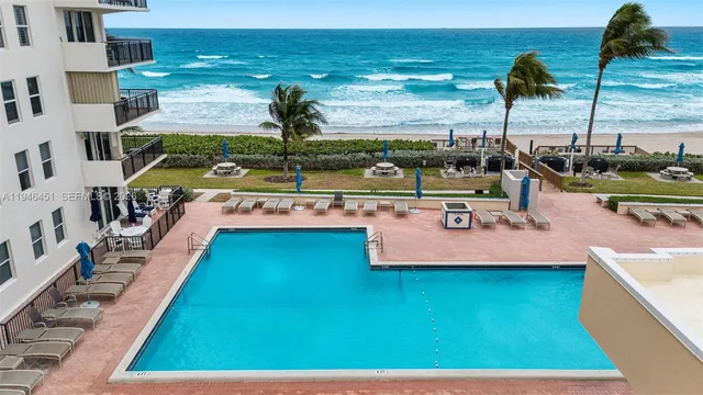 a view of a swimming pool with outdoor seating