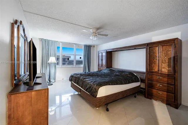 a bedroom with a bed closet and flat screen tv