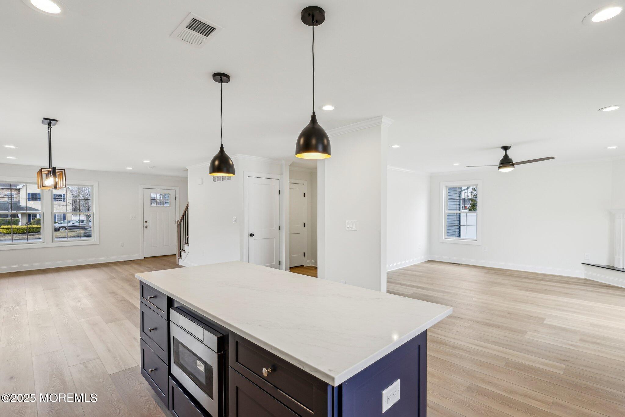 563 Holmdel Road Hazlet, NJ 07730 - Photo 12 of 50 a view of a room with wooden floor and a ceiling fan