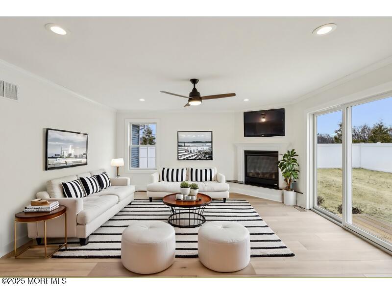 563 Holmdel Road Hazlet, NJ 07730 - Photo 15 of 50 a living room with furniture a fireplace and a flat screen tv