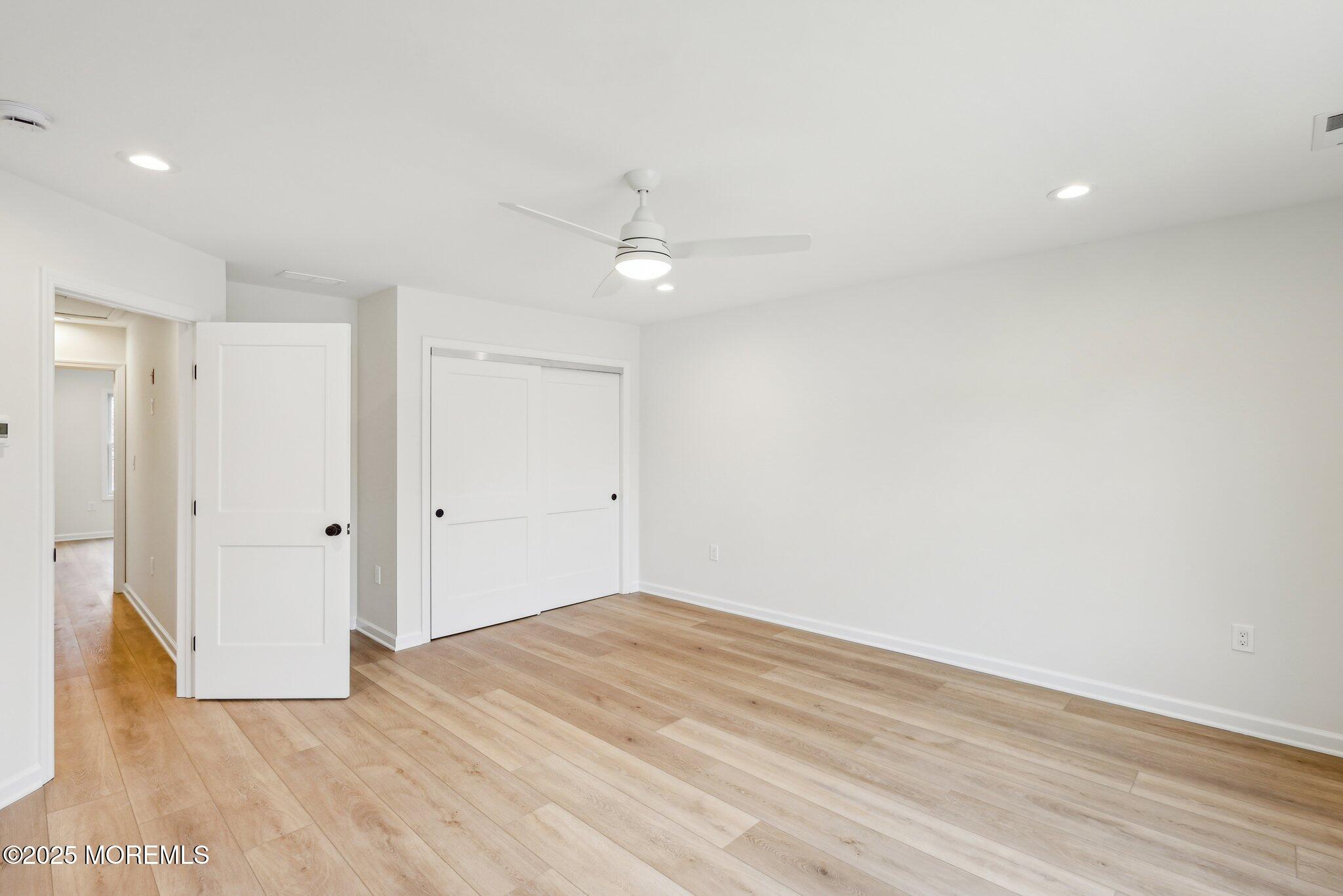 563 Holmdel Road Hazlet, NJ 07730 - Photo 17 of 50 a view of a room with wooden floor and a ceiling fan