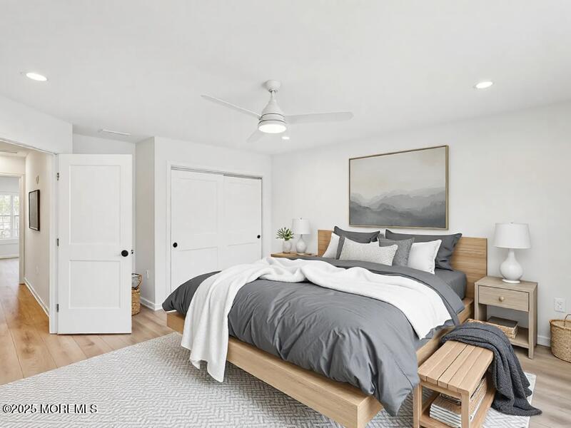 563 Holmdel Road Hazlet, NJ 07730 - Photo 18 of 50 a bedroom with a bed and a chandelier